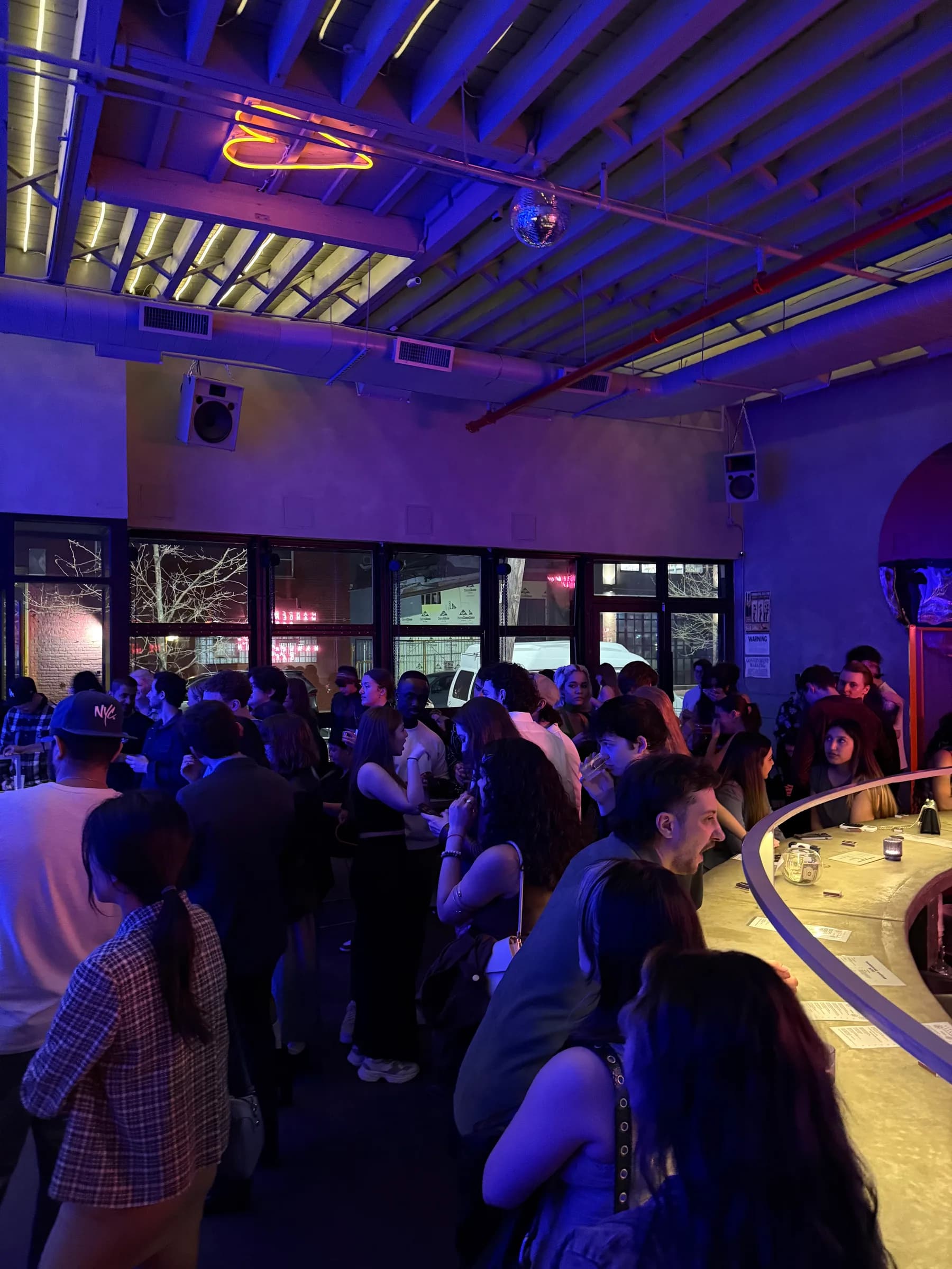 Guests gathered around the bar at a Curation Events evening